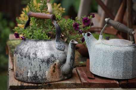 two gray kettles on table